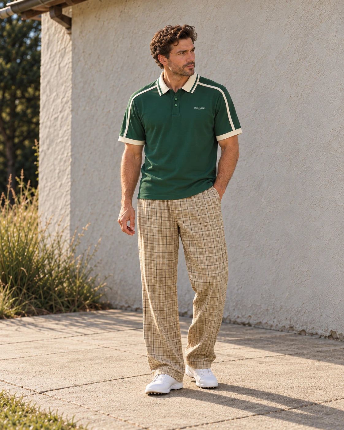 Adult man wearing the Dark Green Links Stripe Polo and Apricot Plaid Pant.